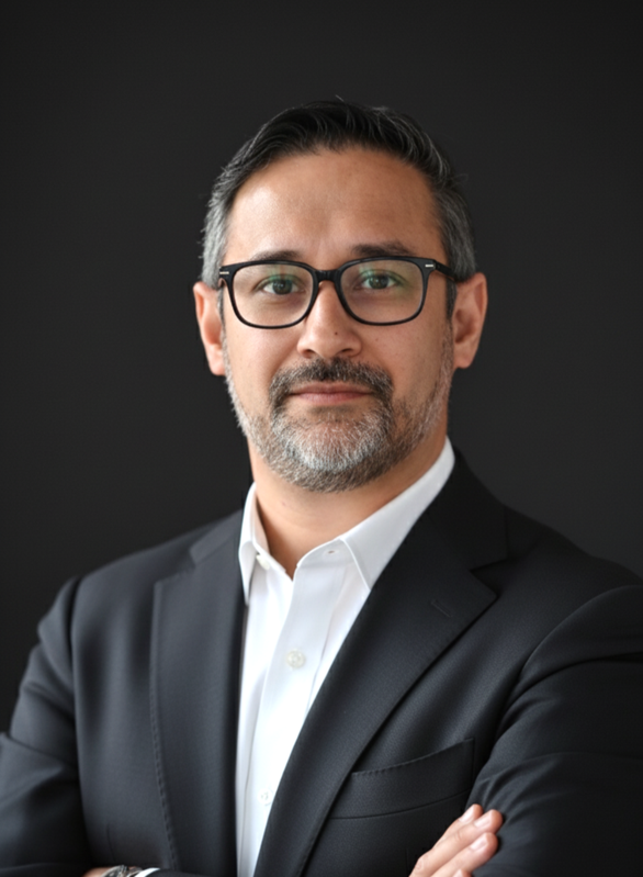 Mukhtar Ahmed, PhD, in a dark jacket and white shirt